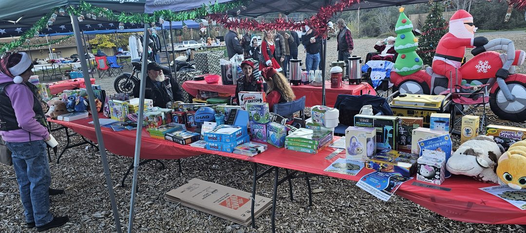 Holiday market tents with vendor tables at the Frost Shop Marketplace.